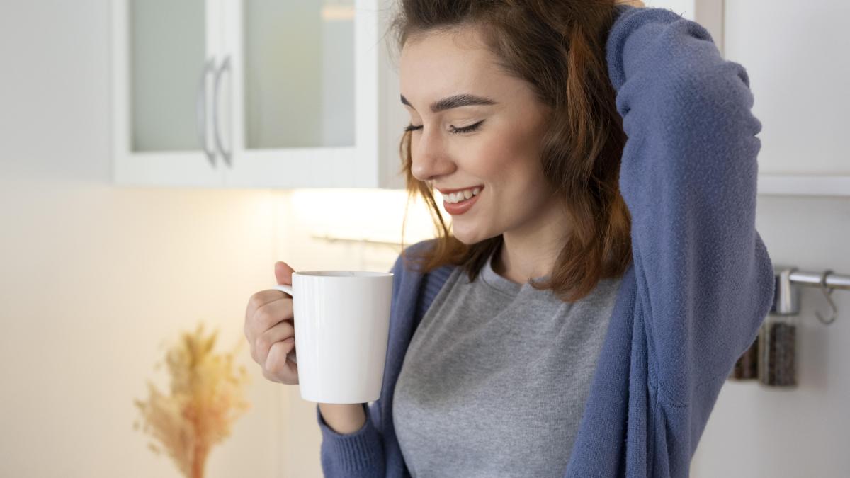woman-holding-cup-close-up_57174400