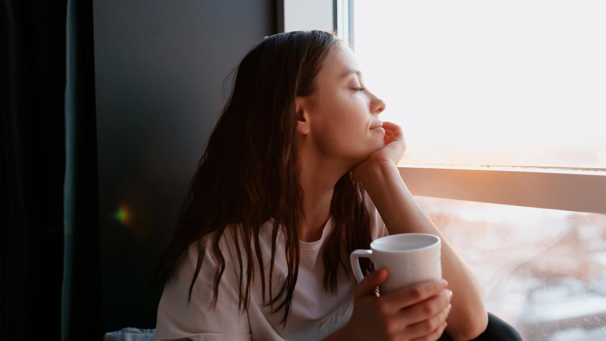 close-up-portrait-romantic-lovely-woman-with-dark-hair-with-wavy-hair-is-closed-eyes-smiling-while-drinking-morning-coffee-sitting-near-window-morning-sunshine_70028900