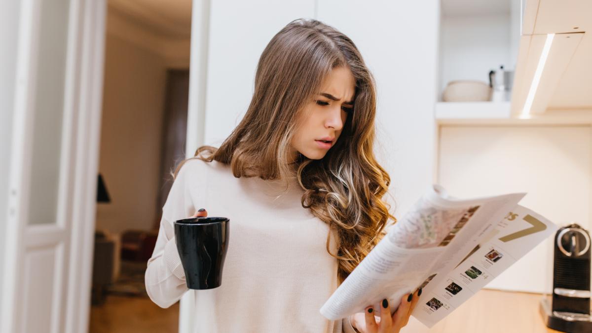 concentrated-dark-haired-woman-reading-magazine-morning-1_17381400