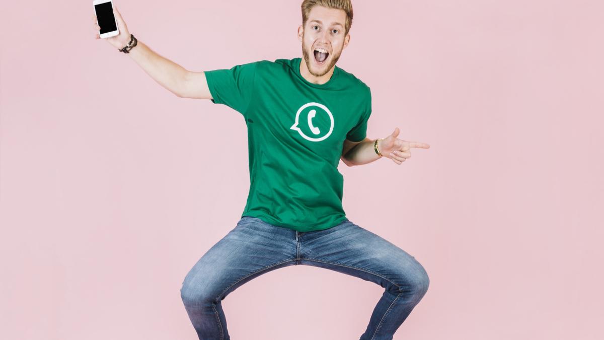 excited-man-with-smartphone-jumping-pink-backdrop-1_37730600