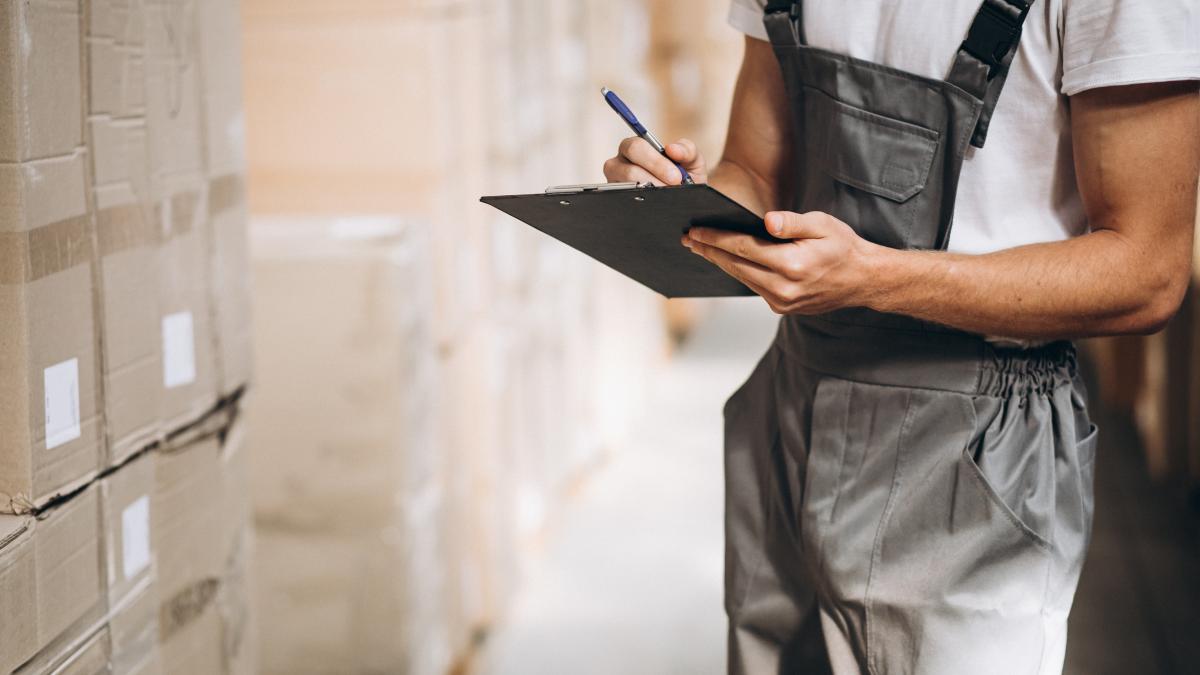young-man-working-warehouse-with-boxes-1_51951600