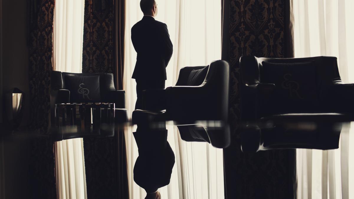 lonely-man-stands-before-window-room_25057200