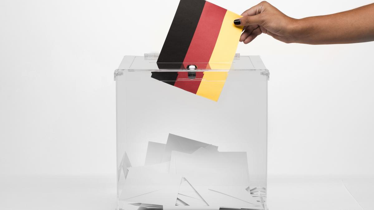 person-putting-germany-flag-card-into-ballot-box_40048600