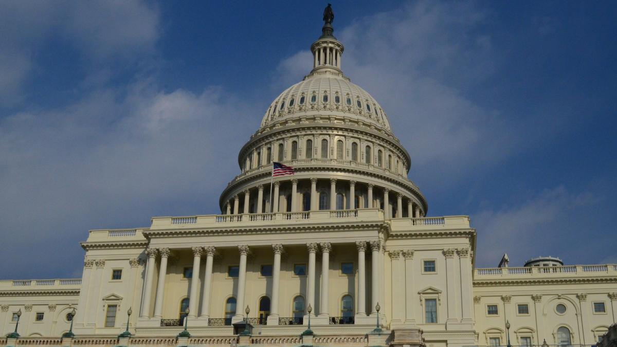 us-flag-flying-capitol-building-washington-dc_07099900
