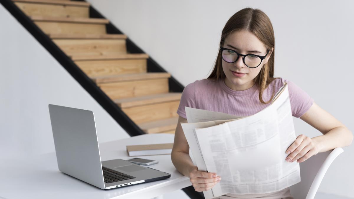 woman-with-glasses-reading-newspaper_10049200
