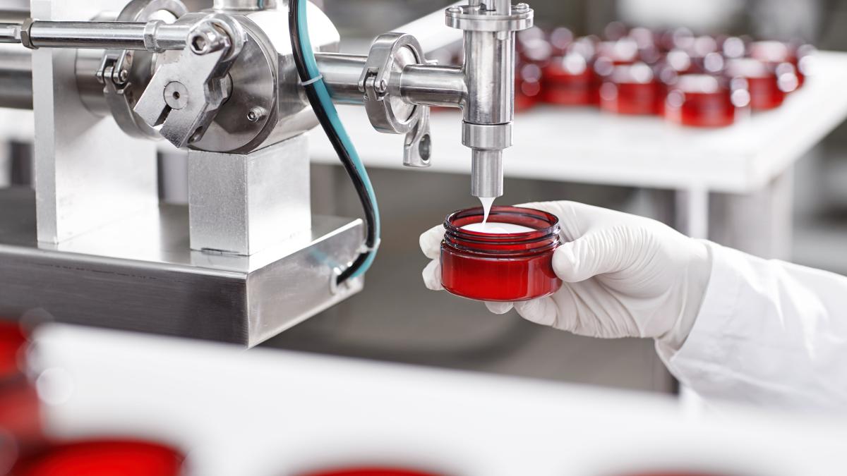 worker-filling-container-with-cream-cosmetic-factory_84997200