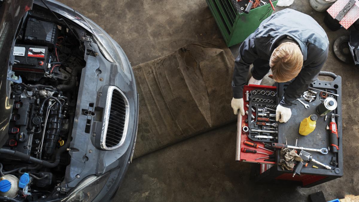 top-view-man-repairing-car_93882000