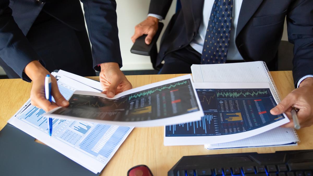 investor-trader-discussing-statistic-data-holding-papers-with-financial-charts-pen-cropped-shot-broker-job-trading-concept_60209800