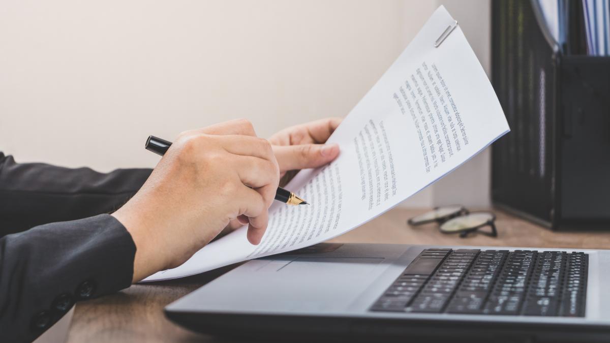 business-woman-checking-paper-working-with-laptop-documents-her-desk_31206500
