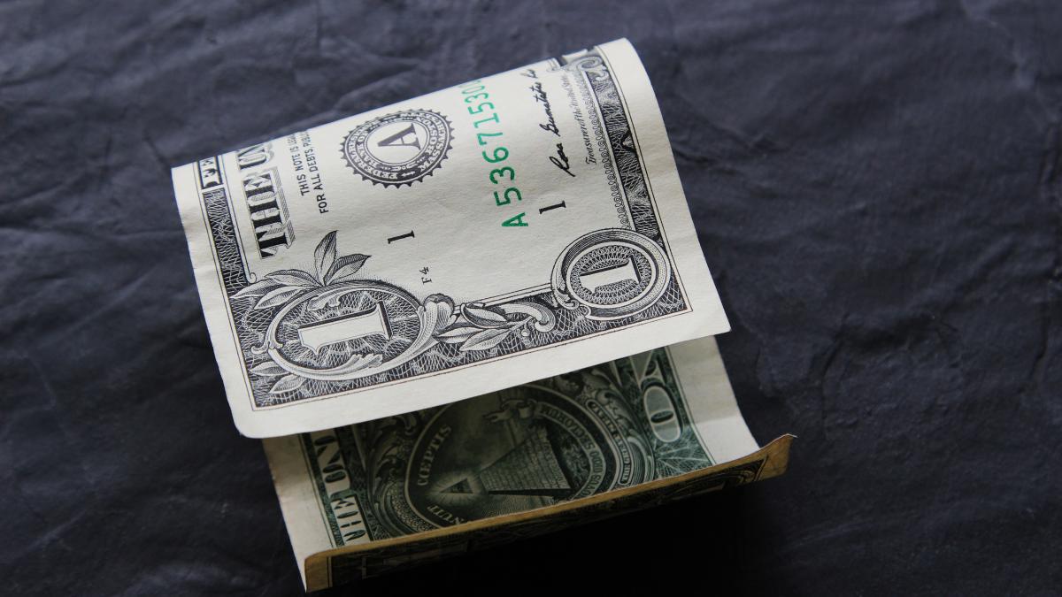 dollar-bill-black-surface_64898000