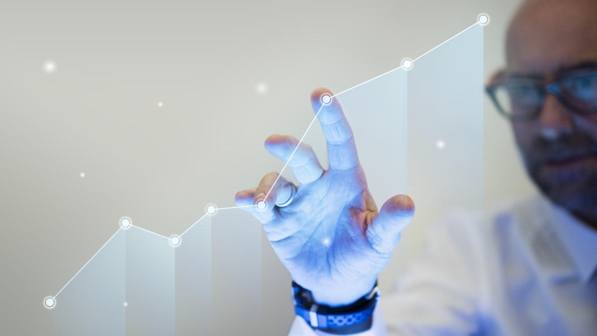 businessman-pointing-his-finger-growth-graph_57464700