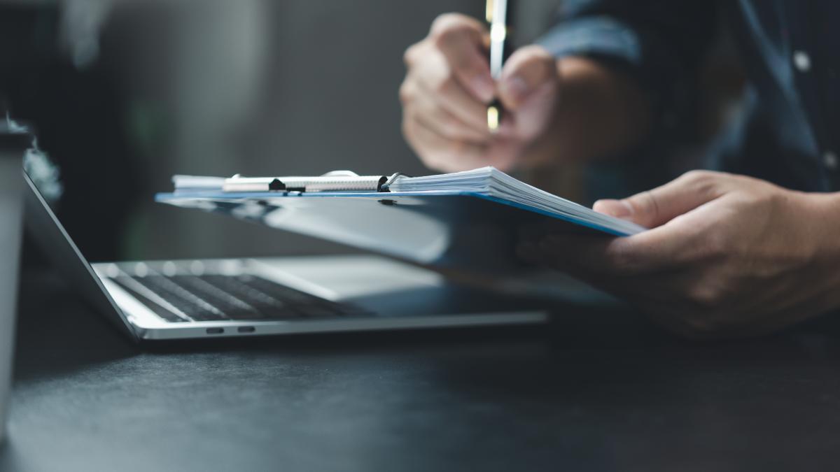 businessman-hand-holding-pen-paperwork-chart-report-document-financial-graph-investment-marketing-tax-insurance-desk_67900000