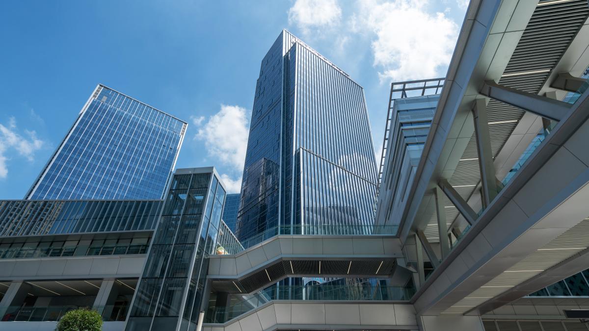 looking-up-blue-modern-office-building_30917900