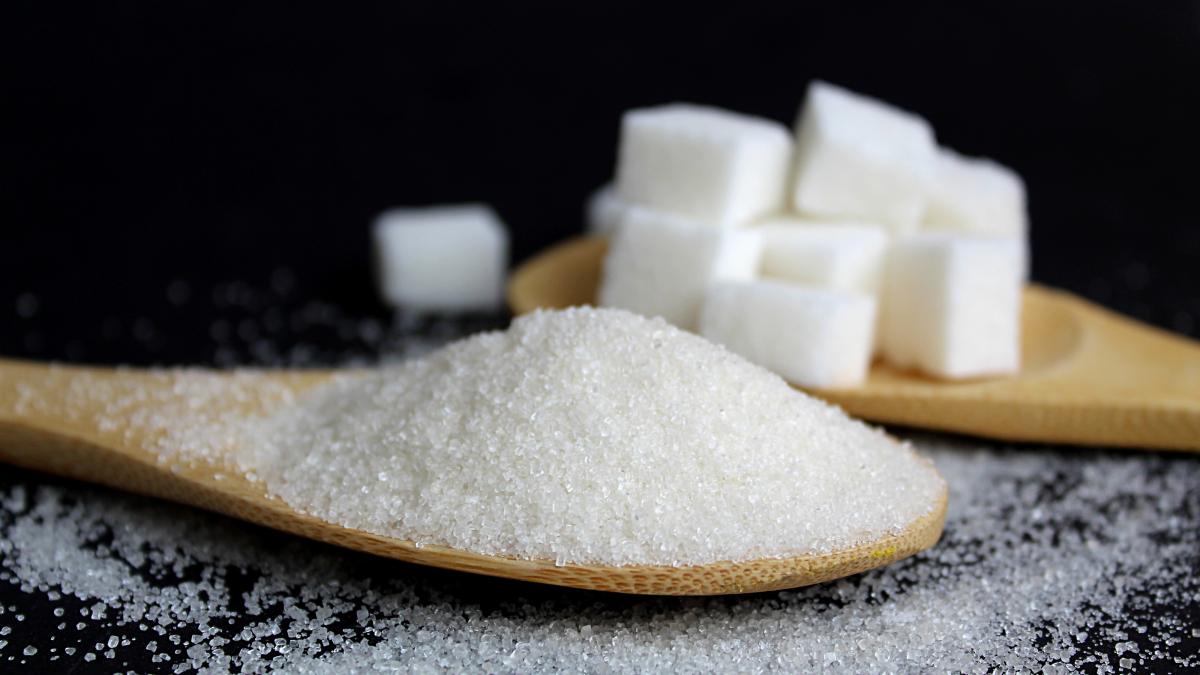 crumbly-sugar-refined-cubes-lie-wooden-spoons-black-wall-delicious-sweet-high-calorie-product_92538800