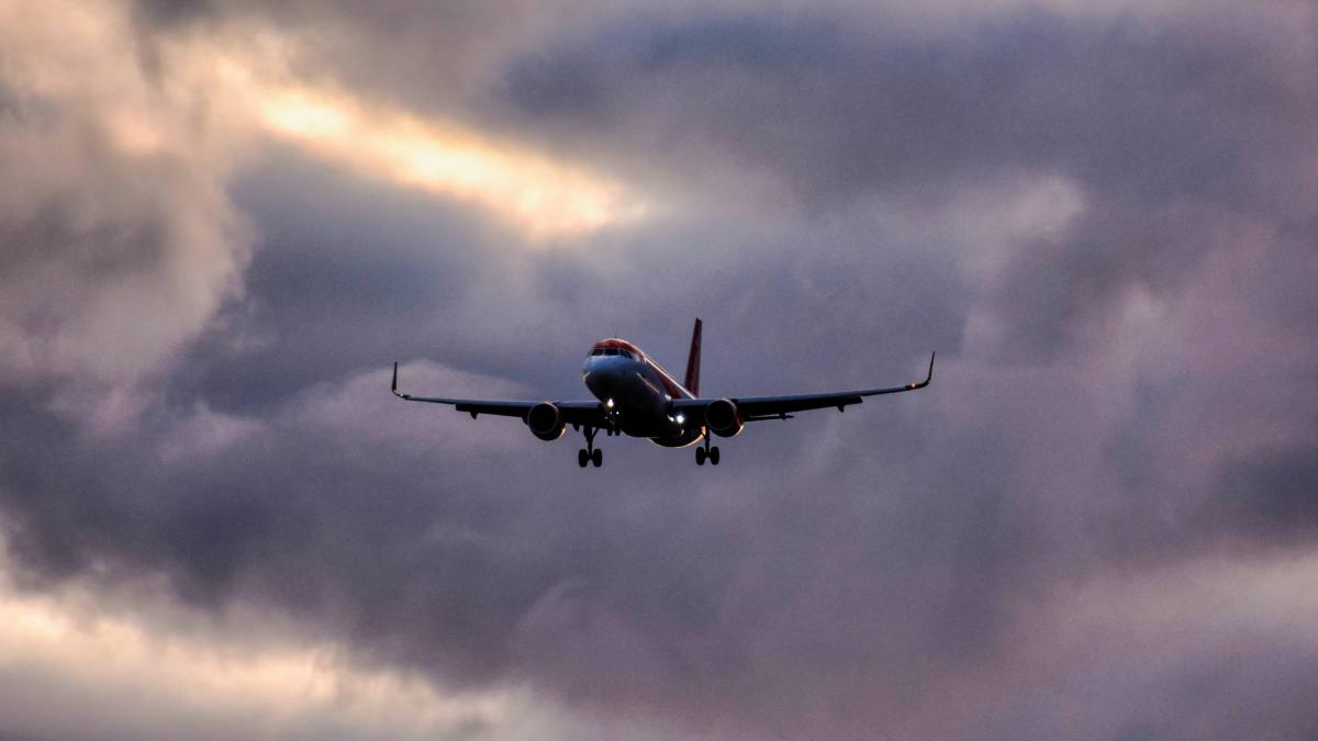 low-angle-shot-airplane-descending-from-clouded-sky_41482300