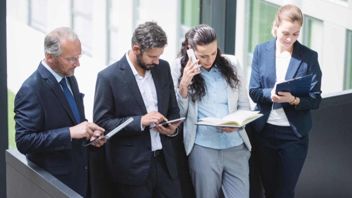 businesspeople-using-mobile-phone-digital-tablet_70719700