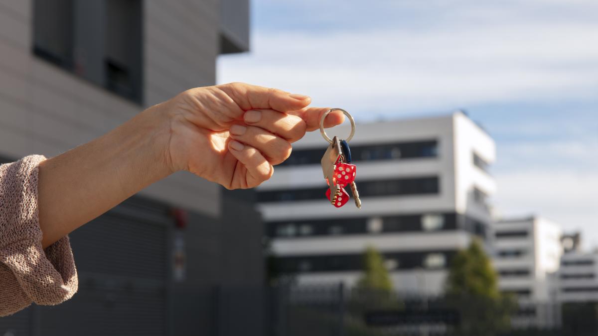 hand-holding-keys-outdoors_13882100