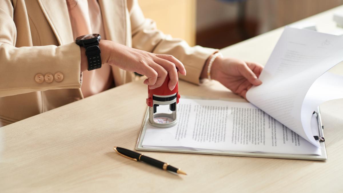 businesswoman-applying-company-seal_62756300