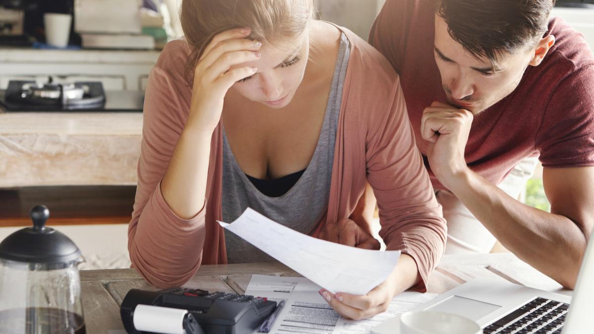 young-couple-calculating-their-domestic-budget-together-kitchen-trying-save-money-buying-new-car-having-stressed-frustrated-looks-unhappy-woman-showing-unpaid-bill-her-husband_46308400