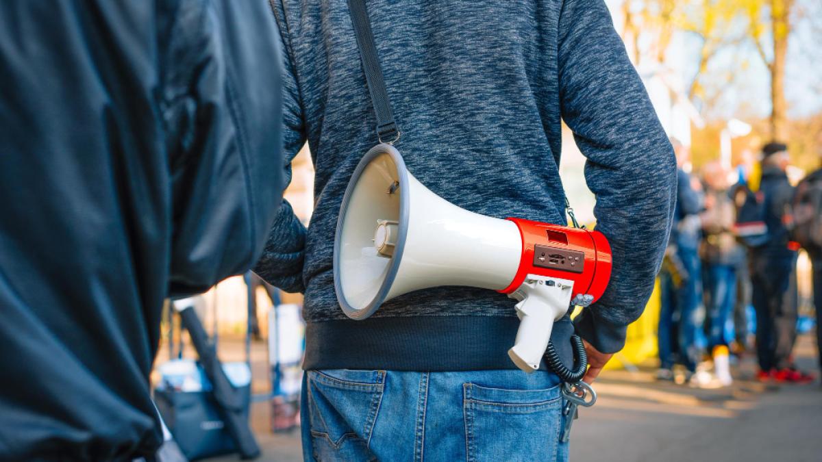protestor-with-loudspeaker-anti-war-rally-person-holding-megaphone_97537000
